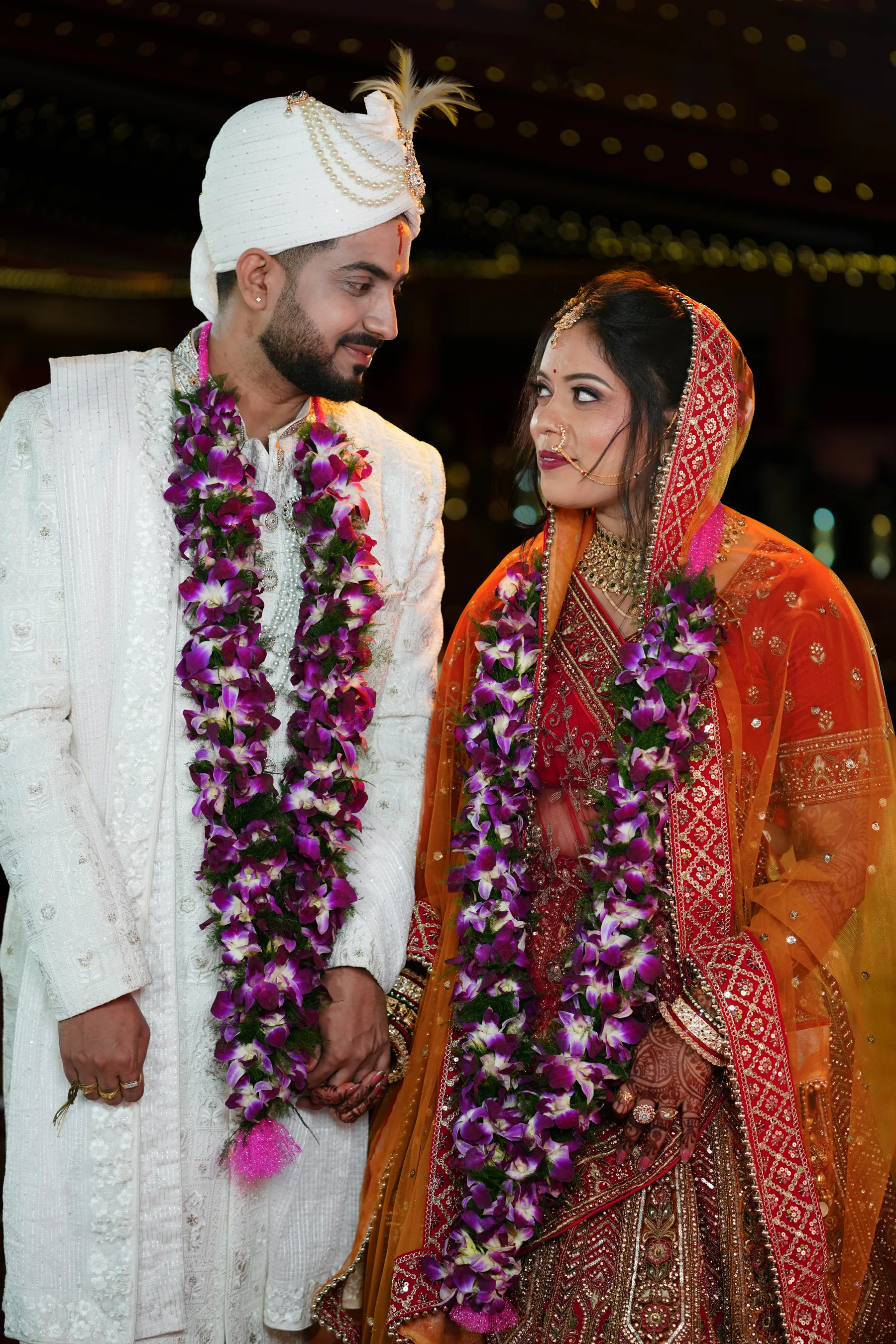 Bride and groom with flower garlands